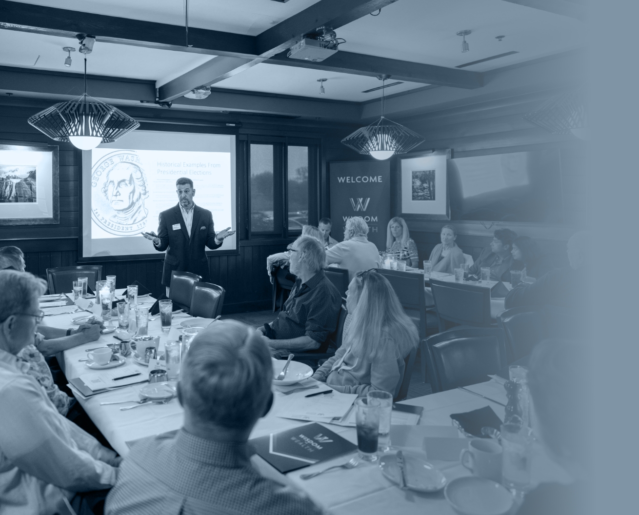 Speaker presenting at dinner meeting- Wisdom to Wealth